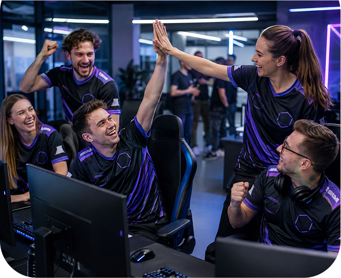 Esports players wearing custom jerseys celebrating together in a gaming room.