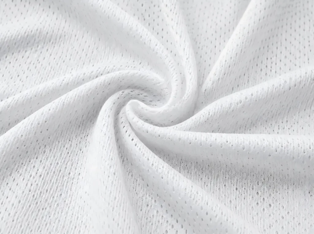 Close-up of white mesh fabric with breathable holes and an enlarged detail of the material.