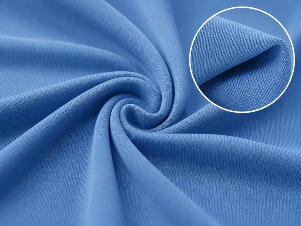 Close-up of blue polyester interlock fabric with a smooth surface and an enlarged fabric detail.